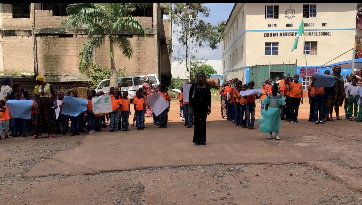 Children lined up on the compound in front of EBOMI Nursery and Primary School.